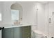 Modern bathroom featuring arched mirror, olive vanity, and glass enclosed shower at 2198 Oakawana Ne Dr, Atlanta, GA 30345