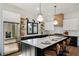 Stylish kitchen boasts stainless steel appliances, black and white cabinets, and seating at the large island at 2198 Oakawana Ne Dr, Atlanta, GA 30345