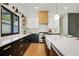 Kitchen featuring an island with seating, white cabinets, stainless steel appliances, and hardwood floors at 2198 Oakawana Ne Dr, Atlanta, GA 30345