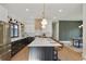 Bright kitchen with black and white cabinets, stone countertops and an island with seating for four at 2198 Oakawana Ne Dr, Atlanta, GA 30345