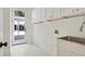 Bright laundry room with ample storage, white cabinets, and modern fixtures at 2198 Oakawana Ne Dr, Atlanta, GA 30345
