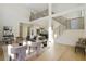 Open-concept living room with a fireplace, hardwood floors, modern decor, and high ceilings at 2198 Oakawana Ne Dr, Atlanta, GA 30345