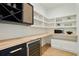 Well-organized pantry featuring white shelving, a wine refrigerator, and ample counter space at 2198 Oakawana Ne Dr, Atlanta, GA 30345