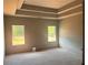 Unfinished bedroom with two windows, and modern tray ceiling at 3108 Marbella Cir # 4, Kennesaw, GA 30152