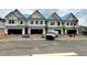 New construction townhomes showcasing garages and the beginnings of their final exterior at 3108 Marbella Cir # 4, Kennesaw, GA 30152