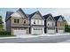 Street view of modern townhomes featuring brick and siding exteriors with two-car garages at 3108 Marbella Cir # 4, Kennesaw, GA 30152