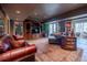Cozy finished basement features a large leather sofa, and a beautiful rug at 622 Goldpoint Trce, Woodstock, GA 30189