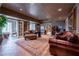 Cozy finished basement features a large leather sofa, french doors, and a beautiful rug at 622 Goldpoint Trce, Woodstock, GA 30189