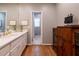 Bathroom with double vanity, hardwood floors, and an antique cabinet for storage at 622 Goldpoint Trce, Woodstock, GA 30189