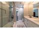 Bathroom with double vanity and glass-enclosed shower with tile and rain shower at 622 Goldpoint Trce, Woodstock, GA 30189