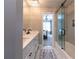 Bathroom with double vanity and glass-enclosed shower with herringbone tile at 622 Goldpoint Trce, Woodstock, GA 30189