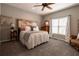 Comfortable bedroom with a unique headboard, soft bedding, and a cozy rocking chair near the window at 622 Goldpoint Trce, Woodstock, GA 30189