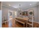 Bright dining room with light wood table, chandelier, hardwood floors, and access to living area at 622 Goldpoint Trce, Woodstock, GA 30189