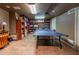 Finished basement featuring a game room with ping pong table and built-in bookshelves at 622 Goldpoint Trce, Woodstock, GA 30189