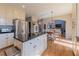 Functional kitchen island with seating, dark countertops, and views to the adjacent living spaces at 622 Goldpoint Trce, Woodstock, GA 30189