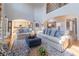 Open-concept living room with hardwood floors, blue and white accents, and seamless flow to the kitchen at 622 Goldpoint Trce, Woodstock, GA 30189