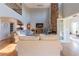 Spacious living room with a soaring ceiling, stone fireplace, hardwood floors, and comfortable seating at 622 Goldpoint Trce, Woodstock, GA 30189