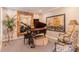 Cozy sitting room with grand piano, decorative mirror, patterned chairs, and stylish decor at 622 Goldpoint Trce, Woodstock, GA 30189