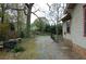 Exterior view of home showing backyard, carport, fence and treed property line at 1130 Ridge Ave, Stone Mountain, GA 30083