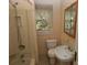 Bathroom with a pedestal sink, medicine cabinet, shower, and natural light at 1130 Ridge Ave, Stone Mountain, GA 30083