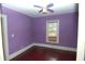 Cozy bedroom with hardwood floors, lilac walls, and a window offering natural light at 1130 Ridge Ave, Stone Mountain, GA 30083