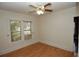 Bedroom featuring wood floors, ceiling fan, and natural light from the window at 1130 Ridge Ave, Stone Mountain, GA 30083