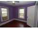 Charming bedroom featuring purple walls, hardwood floors, and a ceiling fan at 1130 Ridge Ave, Stone Mountain, GA 30083