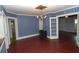 View of the dining room featuring hardwood floors, blue walls, and doorways leading to other rooms at 1130 Ridge Ave, Stone Mountain, GA 30083