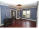 This dining room features hardwood floors, a vintage heater, and a chandelier for a classic touch at 1130 Ridge Ave, Stone Mountain, GA 30083