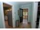 Hallway showcasing the front entrance with view into the kitchen, and a side storage area at 1130 Ridge Ave, Stone Mountain, GA 30083