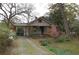 Charming home exterior featuring a covered carport, landscaping, and a welcoming front yard at 1130 Ridge Ave, Stone Mountain, GA 30083