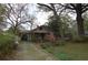 Adorable home featuring a long driveway and mature flowering shrubs at 1130 Ridge Ave, Stone Mountain, GA 30083