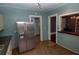 This bright kitchen offers a stainless steel refrigerator and an open layout to dining area at 1130 Ridge Ave, Stone Mountain, GA 30083