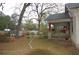 Side yard featuring a well, patio, and lush greenery, perfect for outdoor relaxation and enjoyment at 1130 Ridge Ave, Stone Mountain, GA 30083