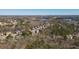 Aerial view of a community nestled among trees, showcasing the homes and nearby lake at 139 Stargaze Rdg, Canton, GA 30114