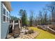 Beautifully landscaped backyard featuring a wooden deck with stairs leading to a patio and rock garden at 139 Stargaze Rdg, Canton, GA 30114