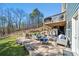 Spacious backyard patio with multiple seating areas, outdoor cooking area, and wooded view at 139 Stargaze Rdg, Canton, GA 30114