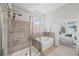 Bathroom featuring a glass-enclosed shower and soaking tub near primary bedroom at 139 Stargaze Rdg, Canton, GA 30114