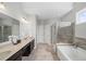 Spacious bathroom features double vanity, tub, and separate shower with glass door at 139 Stargaze Rdg, Canton, GA 30114
