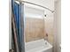 A stylish bathroom with a bathtub featuring tiled walls and a shower head with a blue curtain at 139 Stargaze Rdg, Canton, GA 30114