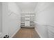 An organized walk-in closet with custom shelving and hanging rods for maximum storage space at 139 Stargaze Rdg, Canton, GA 30114