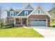 Charming two-story home with a brick and blue siding exterior, a well-manicured lawn, and attached garage at 139 Stargaze Rdg, Canton, GA 30114