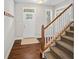 Foyer featuring hardwood floors, stairs with white banister, and a white front door at 139 Stargaze Rdg, Canton, GA 30114