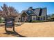 Charming exterior view of the community house with a welcoming sign and beautifully landscaped front yard at 139 Stargaze Rdg, Canton, GA 30114
