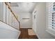 Bright hallway with stairs, hardwood floors, and a white front door with sidelight at 139 Stargaze Rdg, Canton, GA 30114