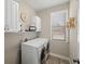 Bright laundry room with washer, dryer, cabinets, and a drying rack at 139 Stargaze Rdg, Canton, GA 30114