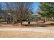 Community playground featuring various play structures, slides, and seating areas, surrounded by trees at 139 Stargaze Rdg, Canton, GA 30114