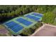 Aerial view of well-maintained community tennis courts surrounded by trees and landscaping with parking nearby at 139 Stargaze Rdg, Canton, GA 30114