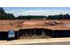View of available lot with visible signage and cleared land for new construction in a wooded area at 6347 Towhee Way, Morrow, GA 30260