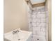 Modern bathroom featuring a new shower with stylish marble-look tile at 165 Holly Nw Rd, Atlanta, GA 30314